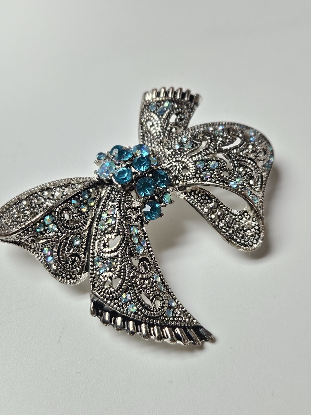 Silver-Tone Bow Brooch with Teal Crystal Cluster